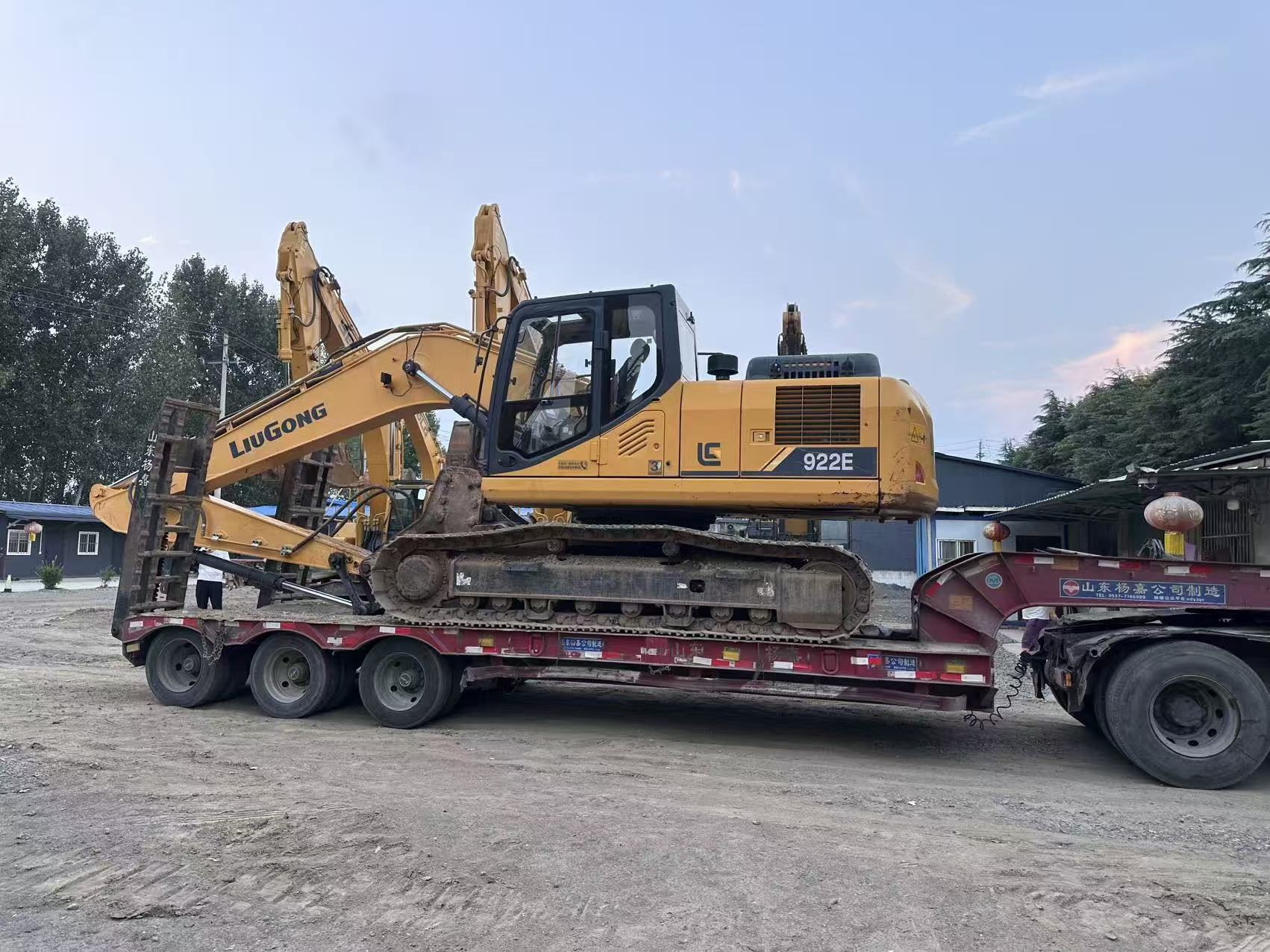 LiuGong crawler excavator on a low-bed trailer during inland dispatch preparation.