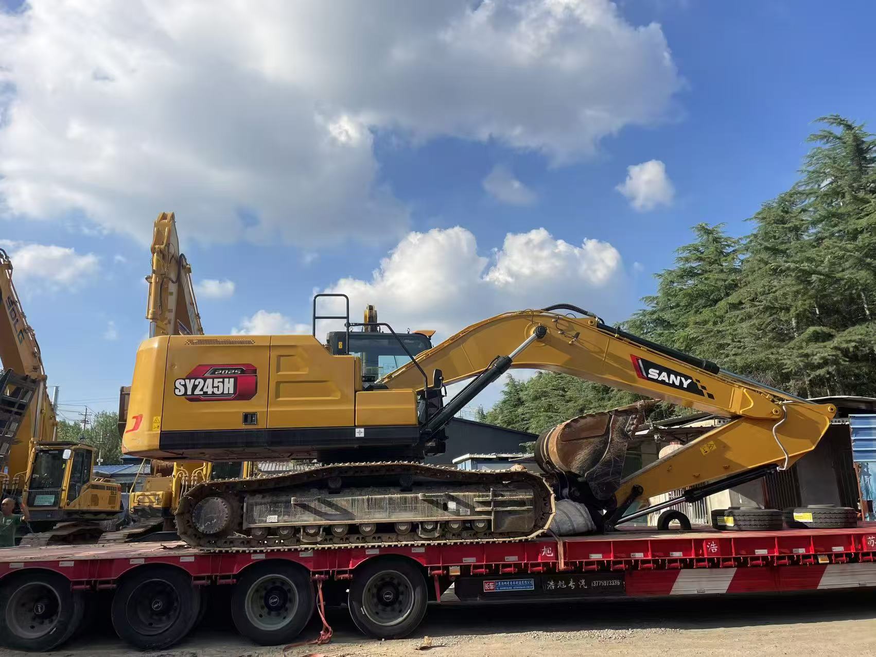 SANY crawler excavator loaded on a low-bed trailer for the inland transport stage.