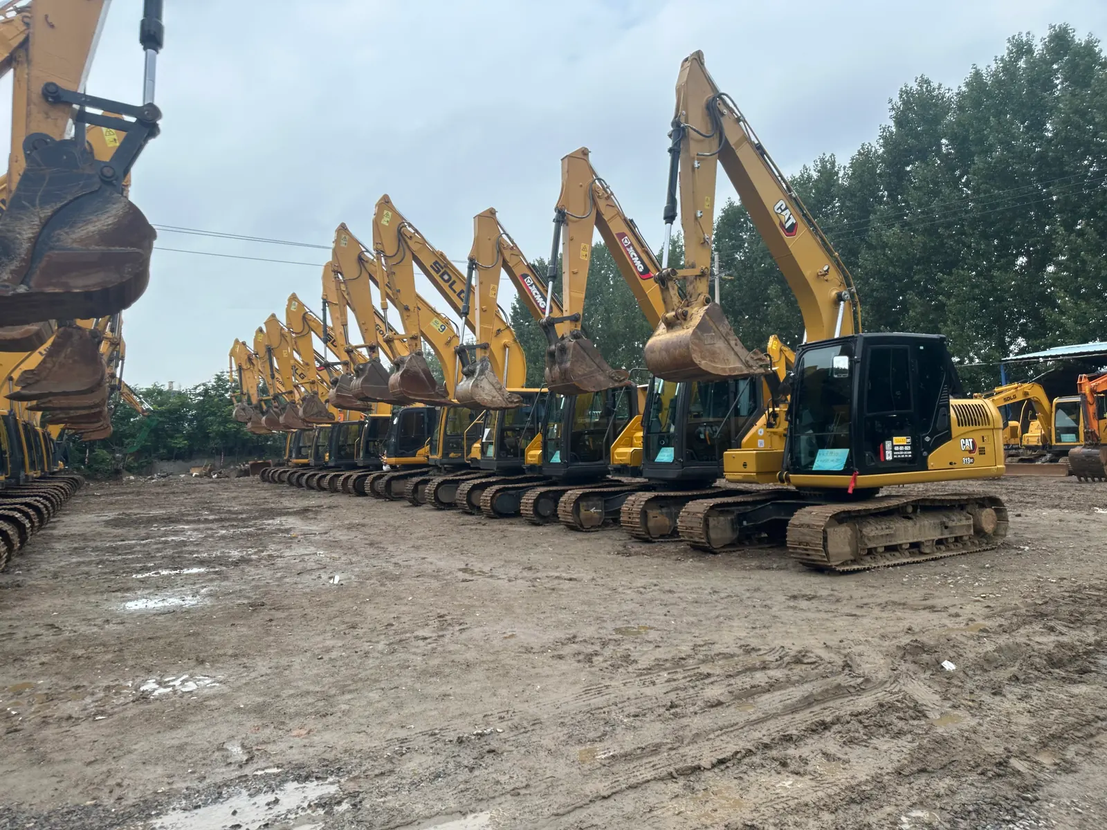 Long line of used excavators in the Plinton Machinery yard