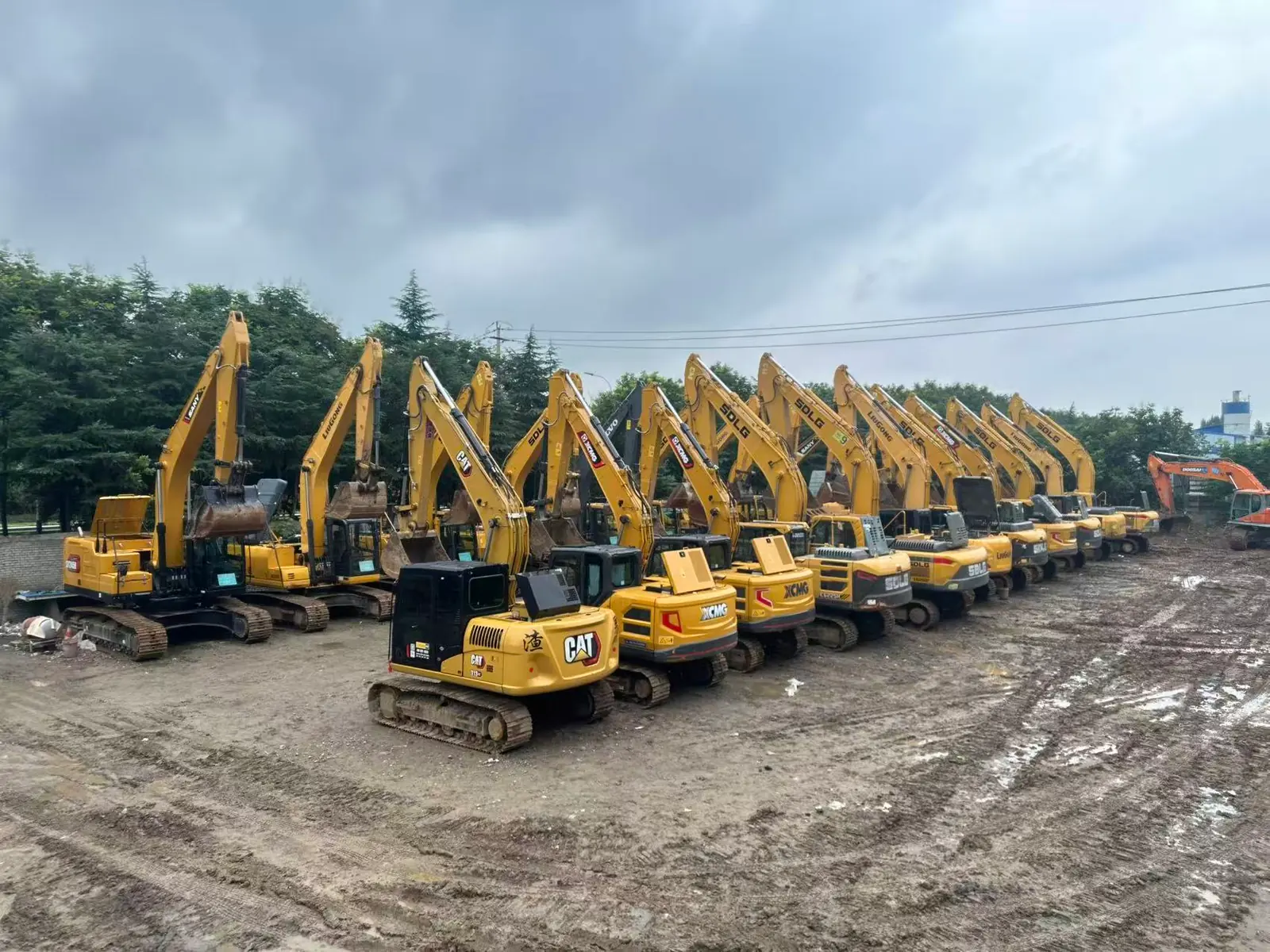 Wide view of used excavators at the Plinton Machinery yard in Zaozhuang